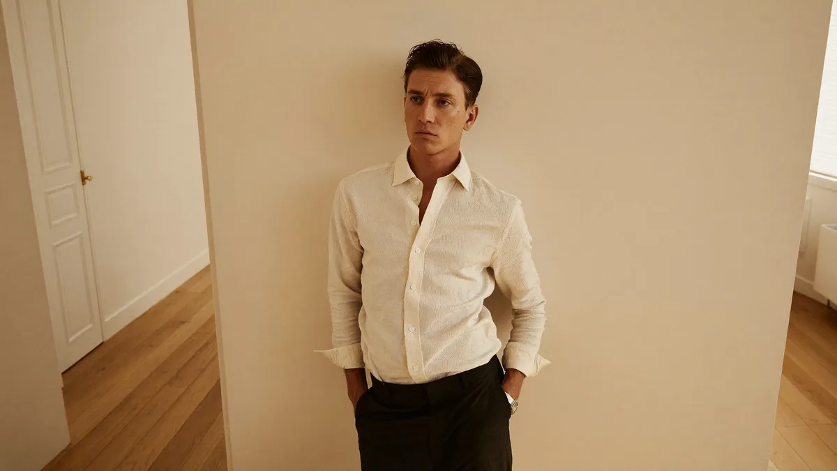 Confident man in well-coordinated casual outfit, natural light, warm editorial
