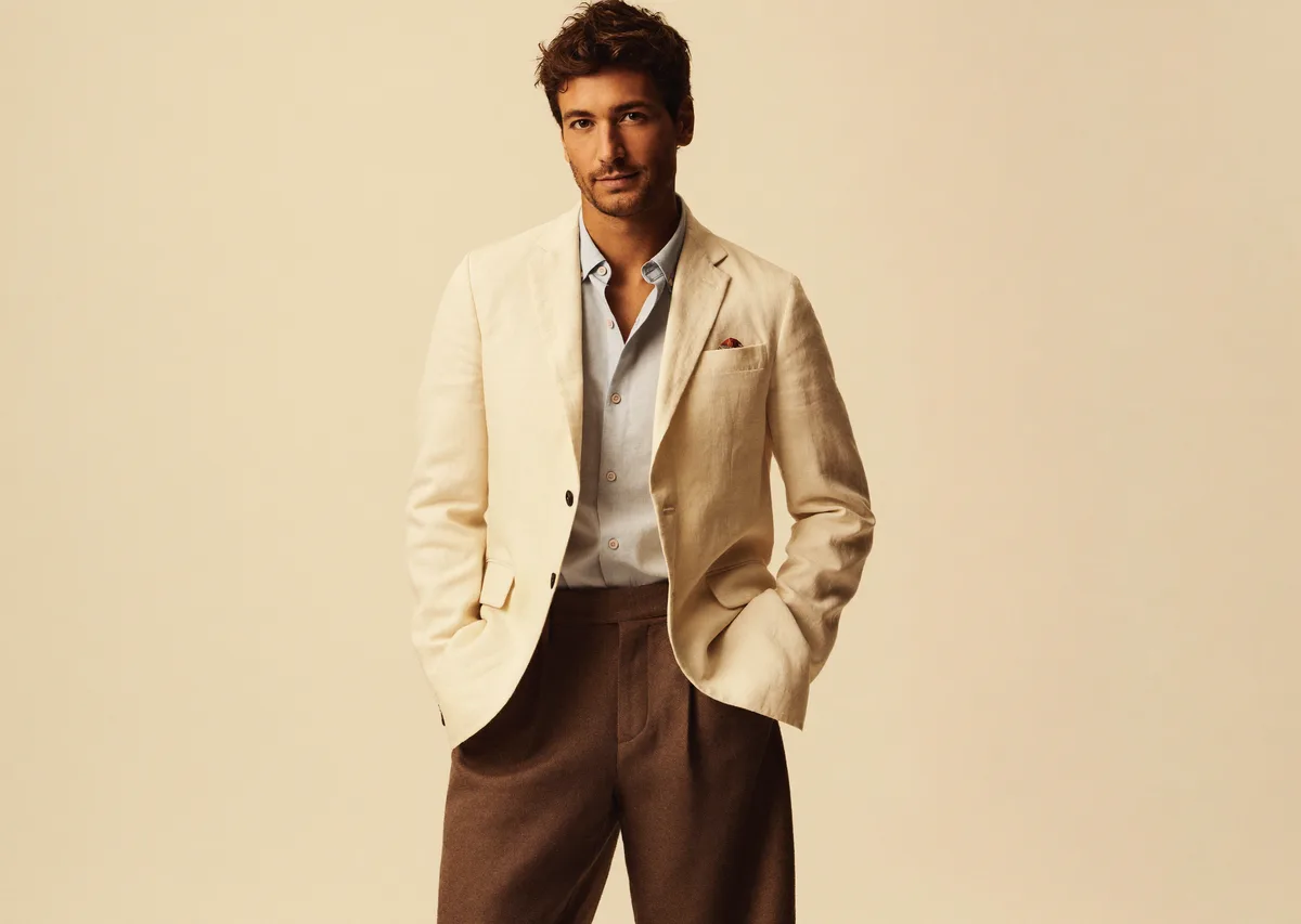Man in sharp open-collar shirt, editorial warm editorial backdrop